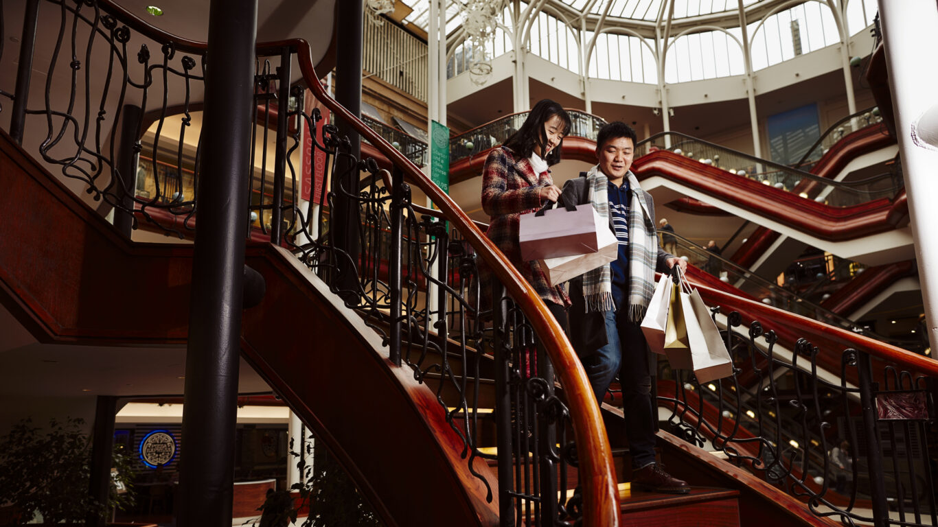 Tourists shopping in Princes Square shopping centre.